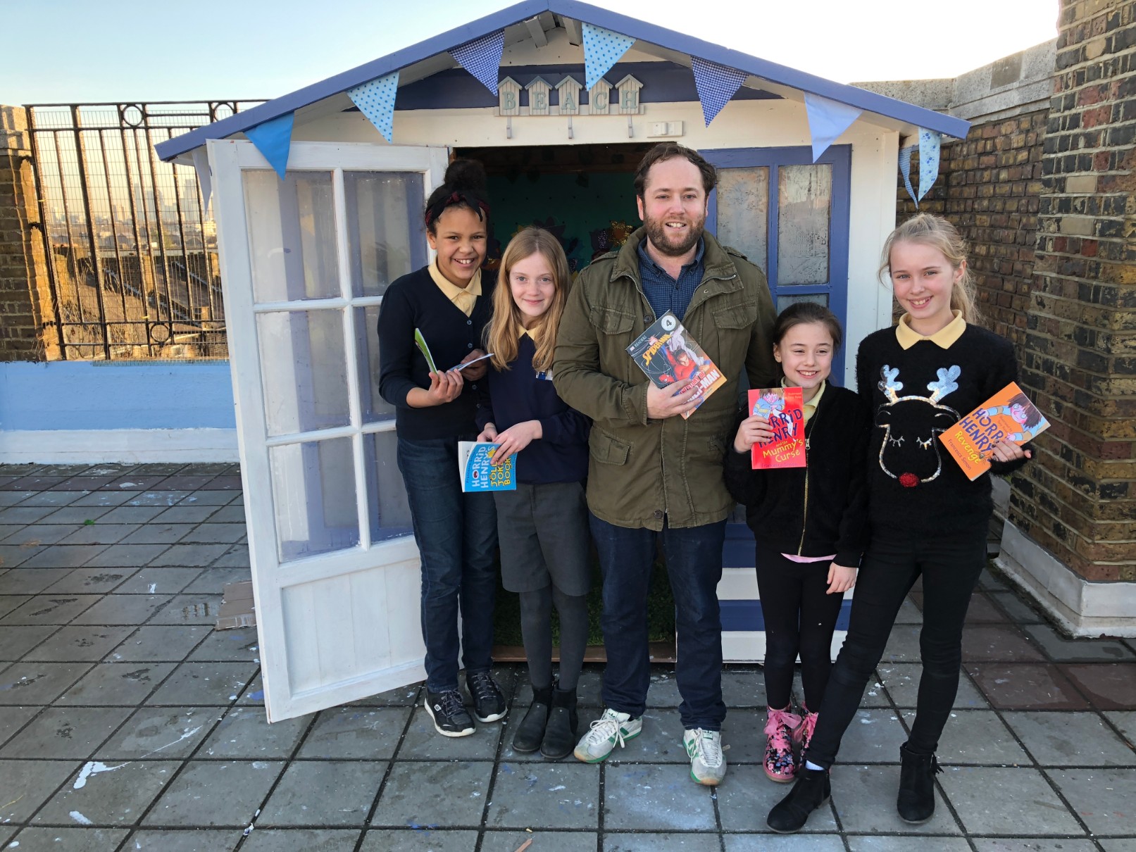 Teacher Matt Williams outside the rooftop library with Brecknock School pupils Zoe Kantazi, Isla Stirton, Cleo Bouch and Casey Gaitens