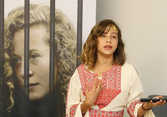 The 12-year-old reporter who’s a thorn in Israel’s side Jana Tamimi South Africa tour standing by a poster photo of her cousin Ahed Tamimi