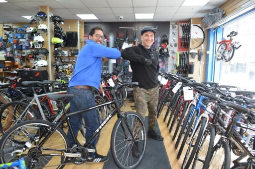 Balrik Kailey receiving his bike from Baha Kenzi at the Bike House