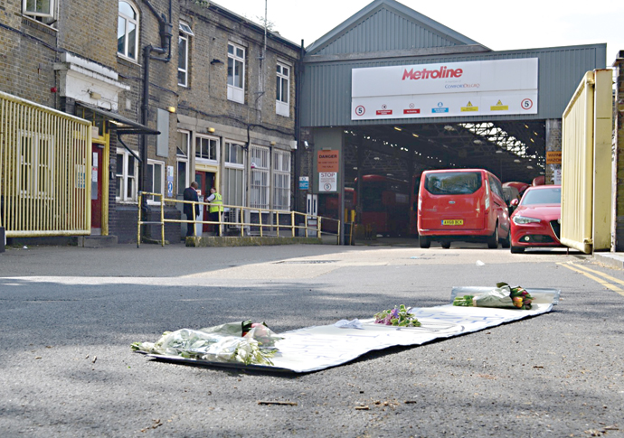 Middle door bus policy is ‘raising risk of virus spread’ as passenger numbers soar Flowers and banner outside bus depot