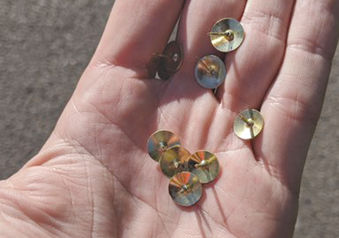 Cyclist drawing pins handful of tacks