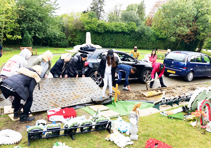 Cemetery downpour: Bereaved left to bail out flood-hit graves of their loved ones Flooded graves 3