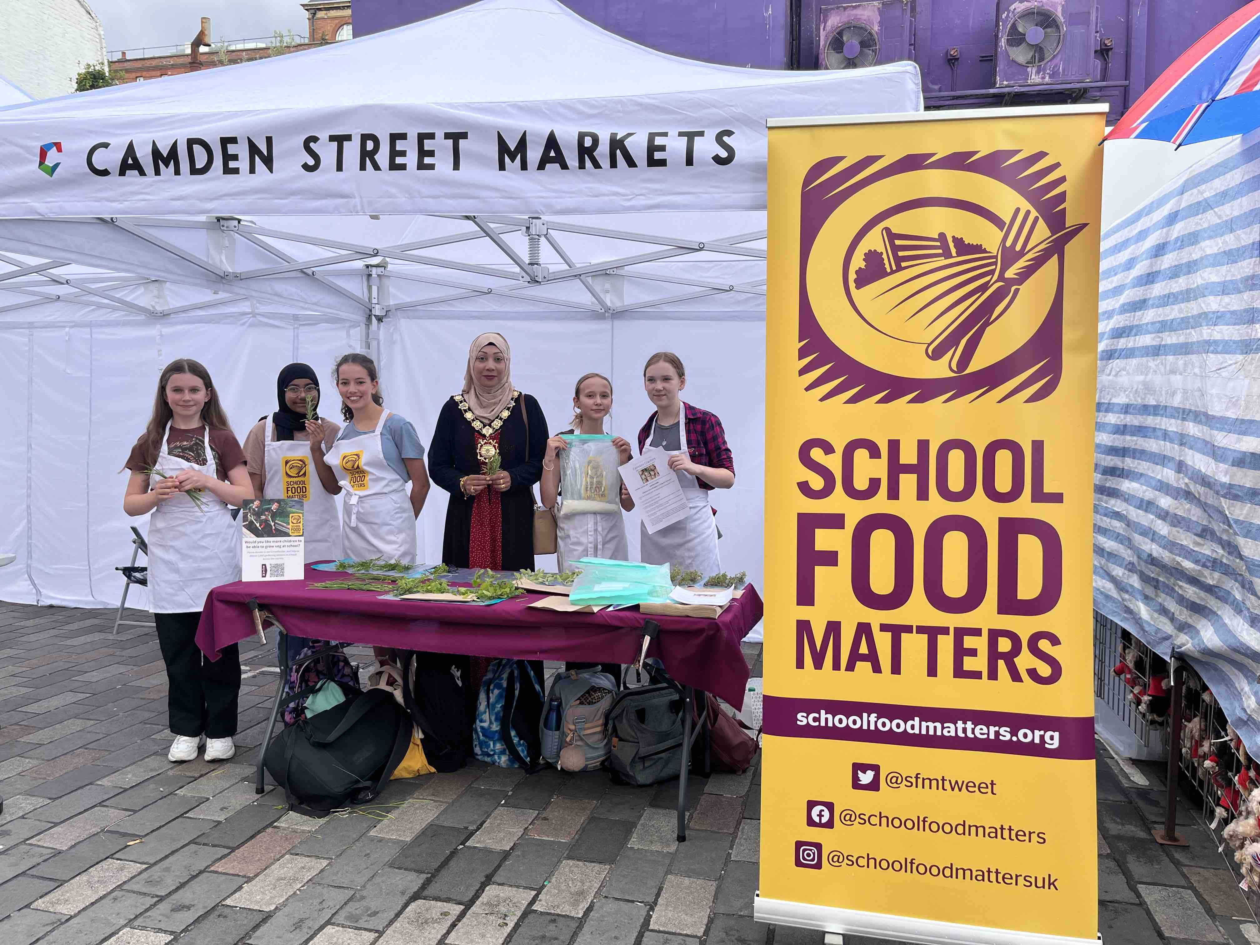 Students try hand at being fruit and veg market sellers in Camden Town Camden School for Girls with Mayor Nazma Rahman