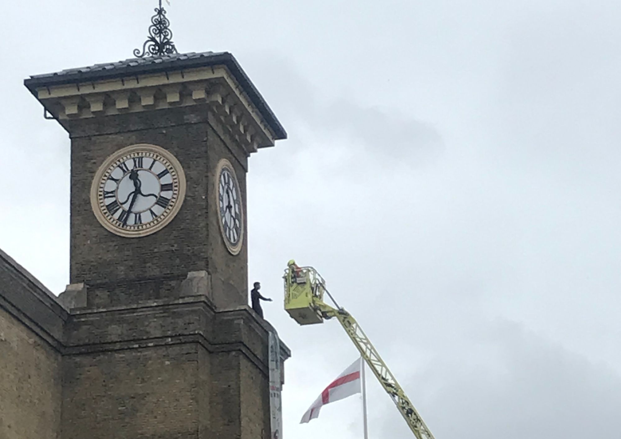 Anti-war protester scales clocktower with pet dog clocktower protest (4)